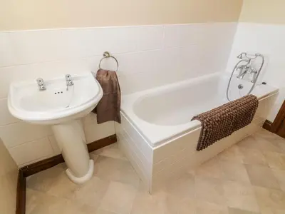 a bathroom with a sink and a bath tub at 1 Netherbeck Barn in Carnforth