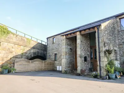 a large brick building with a large garage at 1 Netherbeck Barn in Carnforth