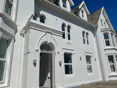 a white building with an archway on the side of it at 1820 Boutique Rooms & Suites in Blackpool
