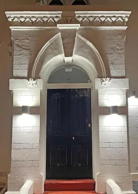 a front door of a building with a black door at 1820 Boutique Rooms & Suites in Blackpool