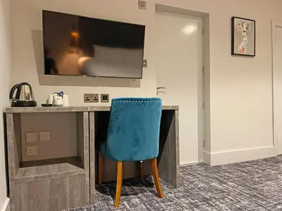 a desk with a blue chair in a room at 1820 Boutique Rooms & Suites in Blackpool