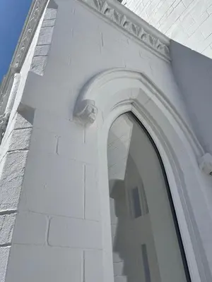 a white brick building with an arch window on it at 1820 Boutique Rooms & Suites in Blackpool