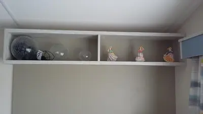 a shelf with a bunch of vases on it at KINGDOM HOLIDAY PARK - Parrot in Millom