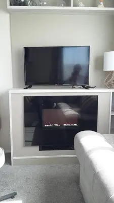 a flat screen tv on a white entertainment center at KINGDOM HOLIDAY PARK - Parrot in Millom