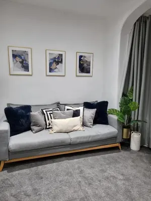 a living room with a couch with pillows on it at Ivy Apartments by CityNest in Blackpool