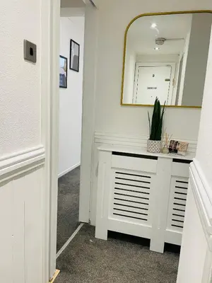 a hallway with a white vanity and a mirror at Ivy Apartments by CityNest in Blackpool