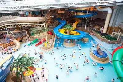 a group of people in an indoor water park at Ivy Apartments by CityNest in Blackpool