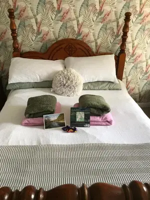 a bed with some pillows and certificates on it at Saltcotes Farm in Ulverston