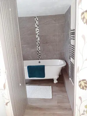 a bathroom with a bath tub in a room at Saltcotes Farm in Ulverston