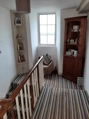 a room with a staircase with a window and a stair case at Saltcotes Farm in Ulverston