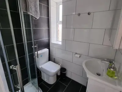 a small bathroom with a toilet and a sink at Granada Apartments at Pleasure Beach in Blackpool
