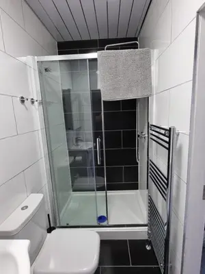 a bathroom with a glass shower with a toilet at Granada Apartments at Pleasure Beach in Blackpool