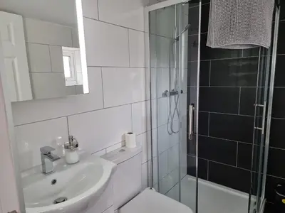 a bathroom with a sink and a toilet and a shower at Granada Apartments at Pleasure Beach in Blackpool