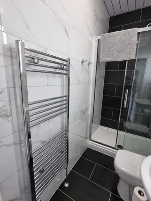 a bathroom with a shower and a toilet at Granada Apartments at Pleasure Beach in Blackpool