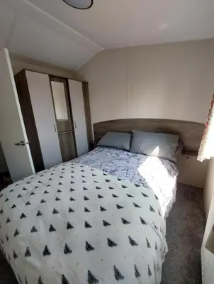 a bedroom with a large bed in a room at Vault 21 in Millom