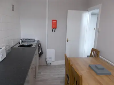 a kitchen with a sink and a counter top at Kelso House holiday flats in Blackpool