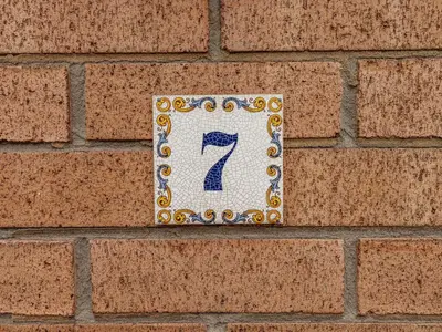 a plaque with the number seven on a brick wall at Spring Close in Southport
