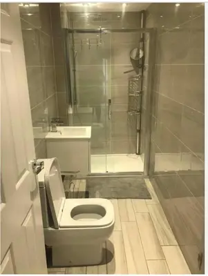 a bathroom with a white toilet and a shower at The Bungaloaf in Walton on the Hill