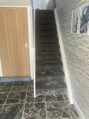a staircase in a building with a door and a stair case at Seagull’s View in Lytham St Annes