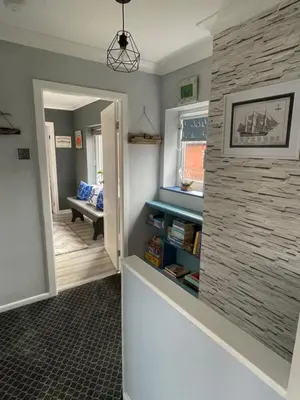 a hallway with a stone wall and a room at Seagull’s View in Lytham St Annes