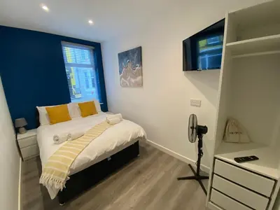 a bedroom with a bed and a camera in it at Blackpool Abode - 20 Bairstow Street in Blackpool