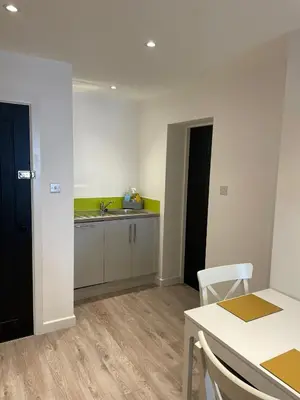 a kitchen with a sink and a table and a counter at Blackpool Abode - 20 Bairstow Street in Blackpool