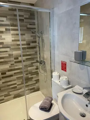 a bathroom with a shower and a toilet and a sink at Blackpool Abode - 20 Bairstow Street in Blackpool