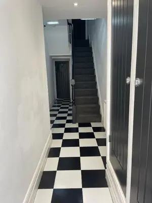 a hallway with a black and white checkered floor at Blackpool Abode - 20 Bairstow Street in Blackpool