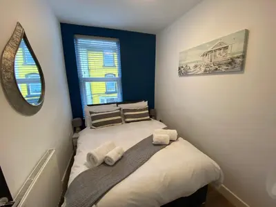 a small bedroom with a bed with towels on it at Blackpool Abode - 20 Bairstow Street in Blackpool