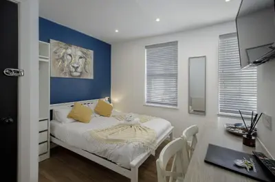 a bedroom with a bed and a desk in it at Blackpool Abode - 20 Bairstow Street in Blackpool