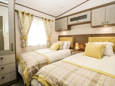 a bedroom with two beds and a window at Ashton Lodge - Sherwood 4 in Carnforth