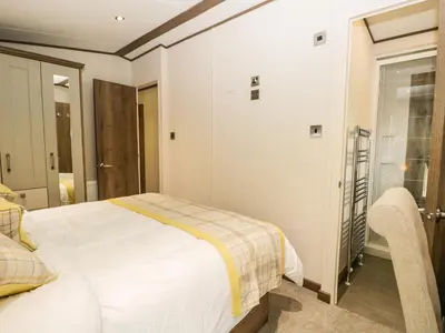 a bedroom with a white bed and a window at Ashton Lodge - Sherwood 4 in Carnforth