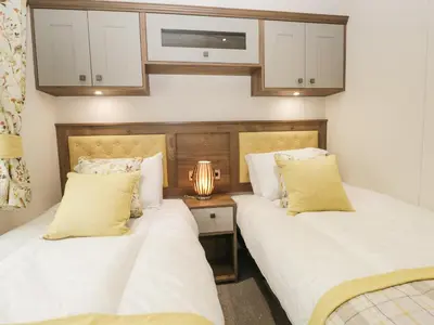 two beds sitting next to each other in a bedroom at Ashton Lodge - Sherwood 4 in Carnforth