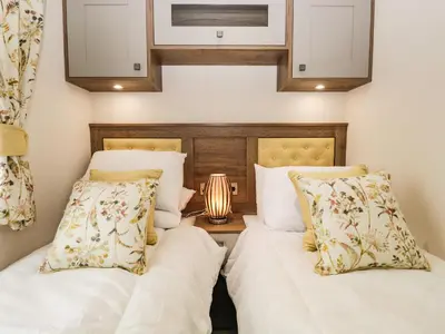 two beds sitting next to each other in a bedroom at Ashton Lodge - Sherwood 4 in Carnforth