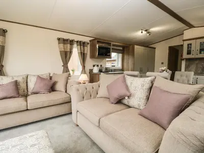 a living room with two couches with purple pillows at Ashton Lodge - Sherwood 4 in Carnforth