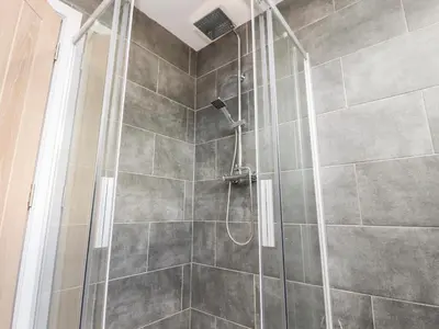a shower with a glass door in a bathroom at Box Tree Escapes in Lancaster