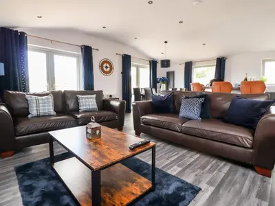 a living room with leather couches and a coffee table at Box Tree Escapes in Lancaster