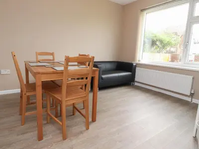 a dining room with a table and chairs and a couch at Kings Walk in Cleveleys