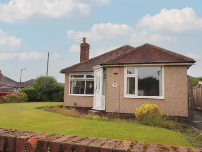 a house with a white door and a yard at Kings Walk in Cleveleys