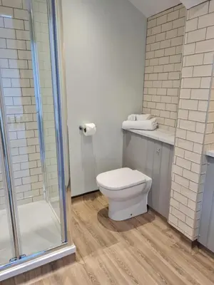 a bathroom with a toilet and a shower at The Stork Hotel in Lancaster