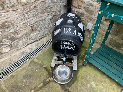 a sign that says waits for a dog pens himself at The Stork Hotel in Lancaster