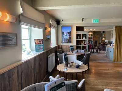 a restaurant with tables and chairs in a room at The Stork Hotel in Lancaster
