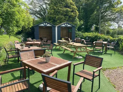 a group of picnic tables and chairs with a shed at The Stork Hotel in Lancaster