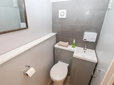 a small bathroom with a toilet and a sink at The Bothy in Lytham St Annes