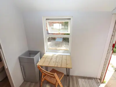 a small table and a window in a room at The Bothy in Lytham St Annes