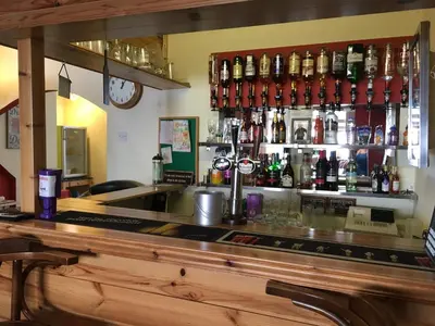 a bar with a lot of bottles of alcohol at Lyndawn hotel in Blackpool
