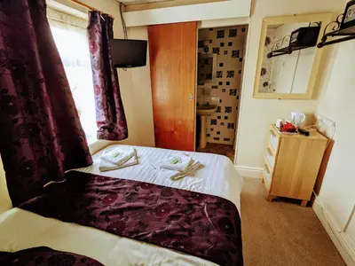 a hotel room with a bed and a window at Lyndawn hotel in Blackpool