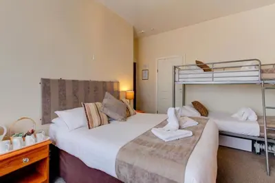 a bedroom with two beds and a bunk bed at Lyndawn hotel in Blackpool