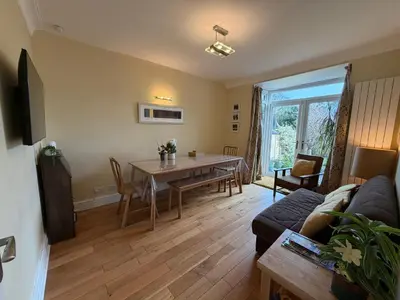 a living room with a table and a couch at Bare, Morecambe - Parking EV, 2 Bathrooms, 3 King Bedrooms, Good Area in Morecambe
