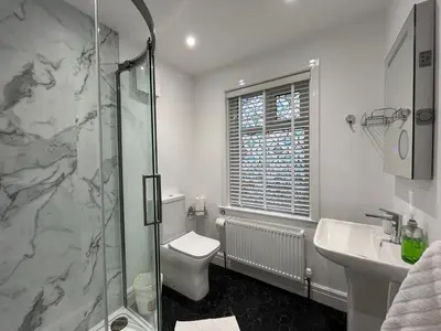 a bathroom with a shower and a toilet and a sink at Bare, Morecambe - Parking EV, 2 Bathrooms, 3 King Bedrooms, Good Area in Morecambe